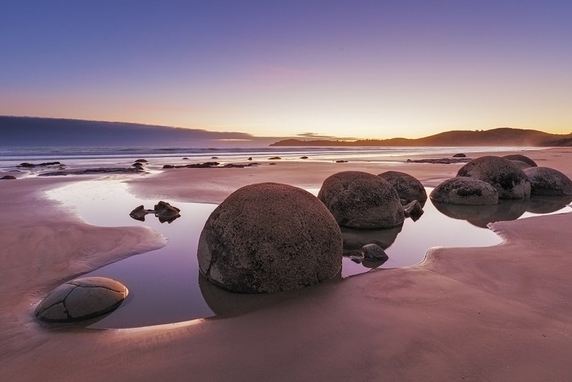 Moeraki Boulders along Koekohe Beach - Hampden | Secret World Trip Planner